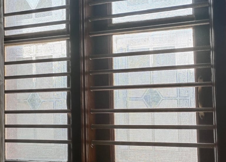 Wide shot of a modern Bangalore balcony with a securely installed mosquito net.