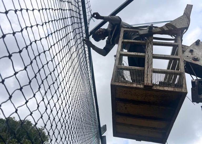 Happy family enjoying a pigeon-free balcony, with safety nets visible in the background.