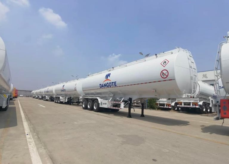 A row of white Dangote cement tanker trailers parked aftr production