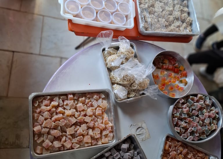 Assorted trays of colorful Turkish delight and traditional sweets on a display table.