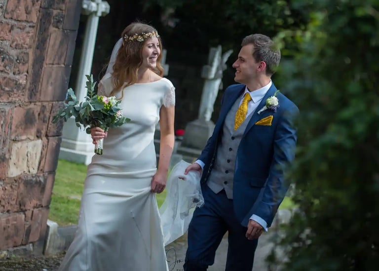 bride and groom walking around church grounds
