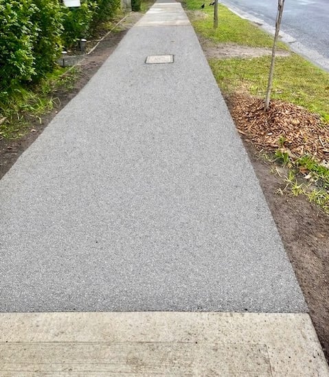 Permeable shared path paving designed to reduce root displacement and improve water infiltration in