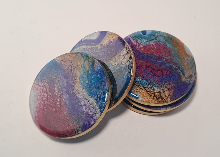 Handcrafted coasters, glossy resin art in swirling ocean blue, deep purple and gold cellular pattern
