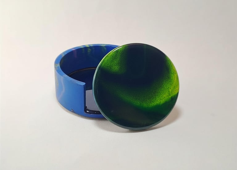 Handmade green and blue swirl resin coaster set with matching holder with northern lights design.