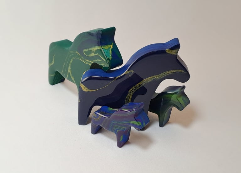 Handcrafted blue and green marbled resin horse figurines in various sizes.
