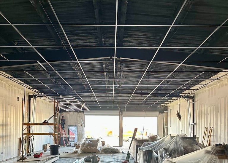 Structural ceiling grid installation for large-scale commercial lighting projects in Florida