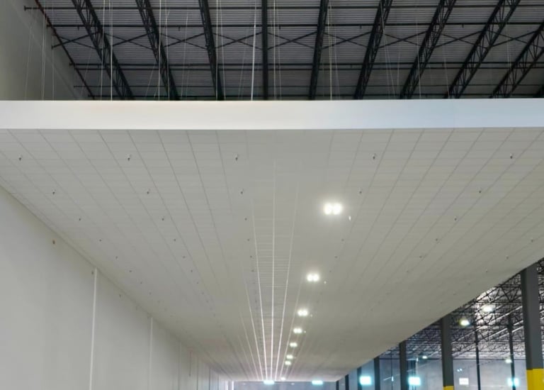 Large-scale acoustic ceilings installation for industrial warehouse in Florida.