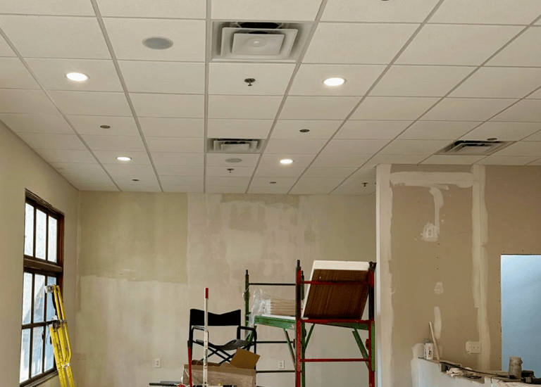Completed acoustic ceilings with integrated recessed lighting and HVAC vents