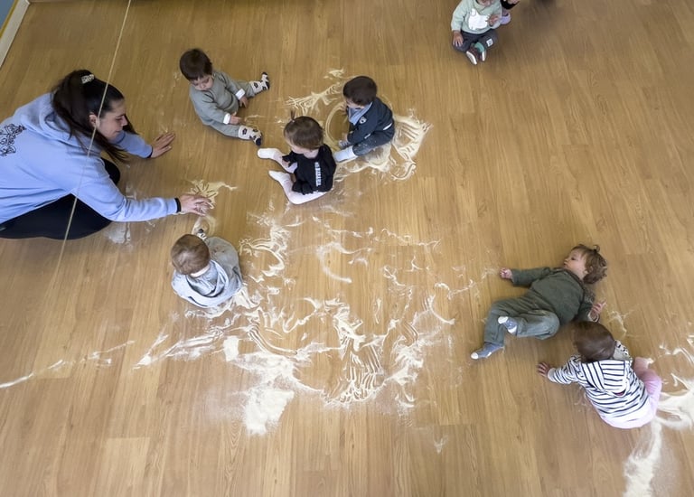 Taller sensorial amb farina, on els infants experimenten i aprenen jugant.