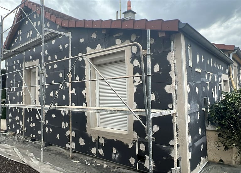 a house with a black and white polka doting on the side of the house