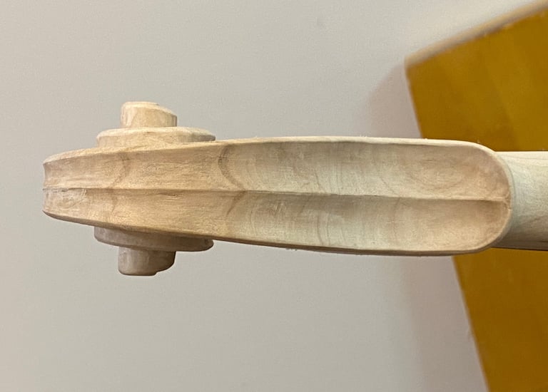 Local tone-wood seen here in the white is used for carving the violin scroll