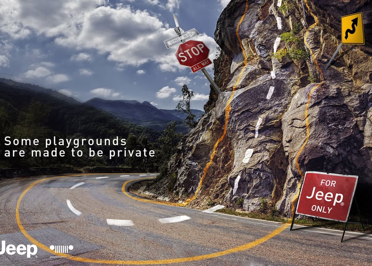 Jeep advertising campaign showing a winding mountain road blending into a rocky cliff with road mark