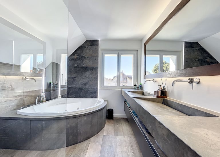 natural bathroom design with stone finishes, built-in bathtub and warm wood elements