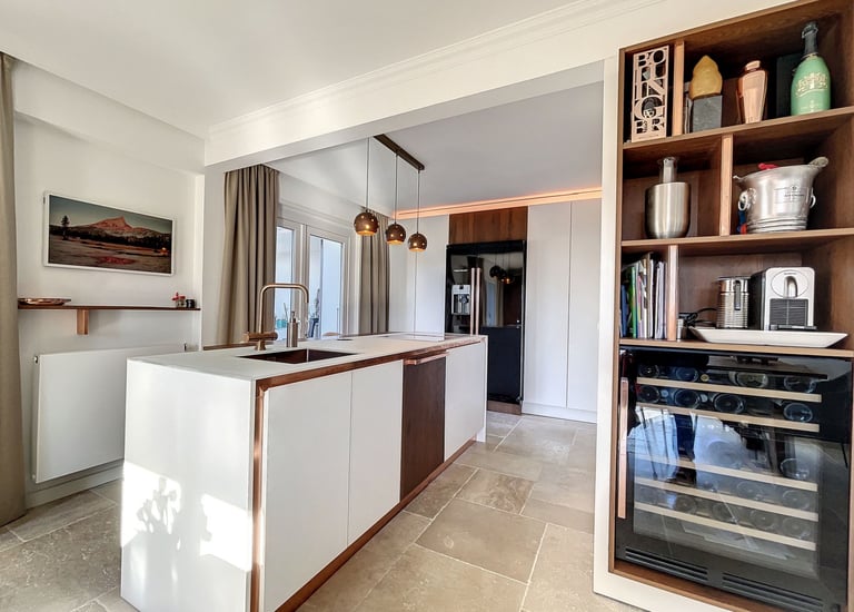 natural kitchen design with wood details, white cabinetry and stone flooring