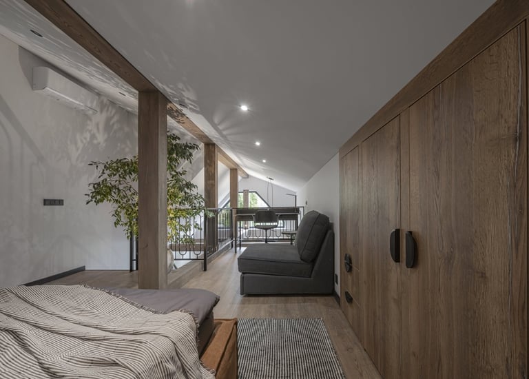 a bedroom with a bed and a couch