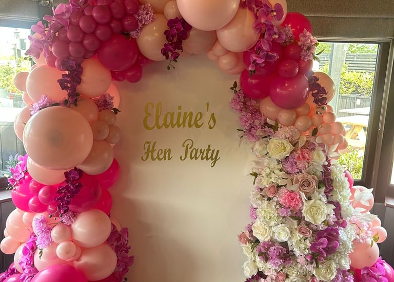 Elegant pink balloon arch and floral display for Elaine's Hen Party decorations.