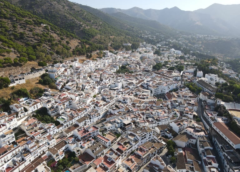 Aerial view of Mijas Pueblo with white houses and mountain landscape in Sierra de Mijas, Spain