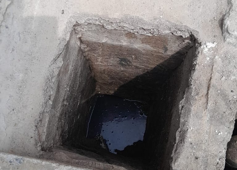 a person standing in a hole in a concrete wall