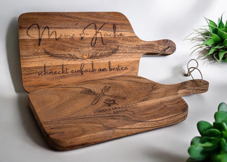 a wooden cutting board with a wooden paddle and a plant