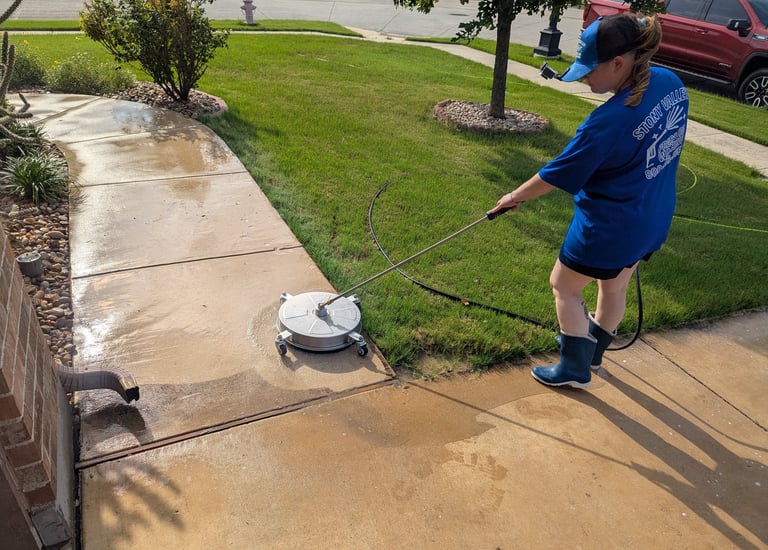 Cleaning a side walk in Ponder Texas.