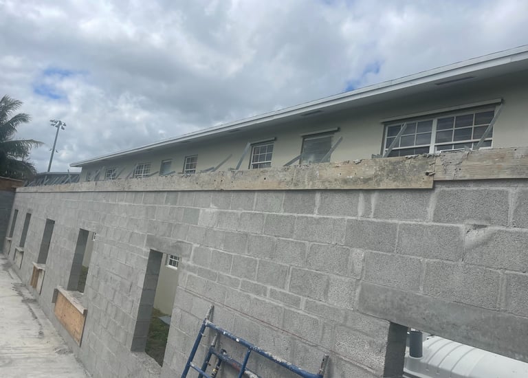 Building block wall with concrete tie beam and inbeeded straps ready for truss install