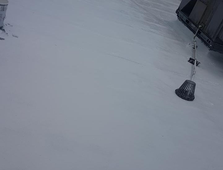 a flat roof with an American weatherstar waterproof roofing system 