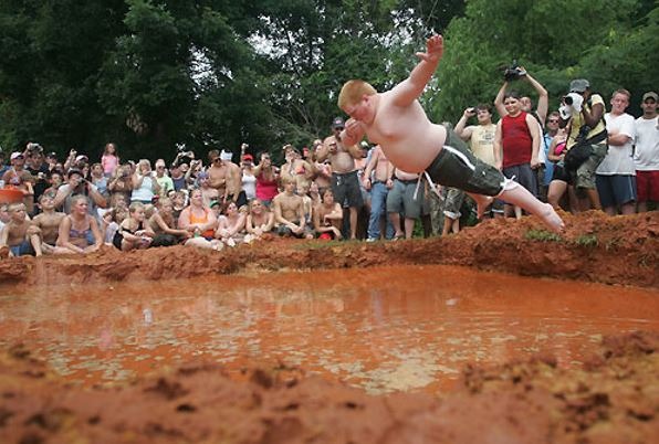 Boy jumping into mud 