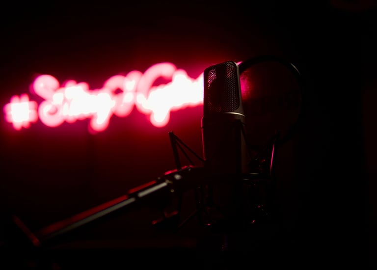 a microphone in front of a neon sign
