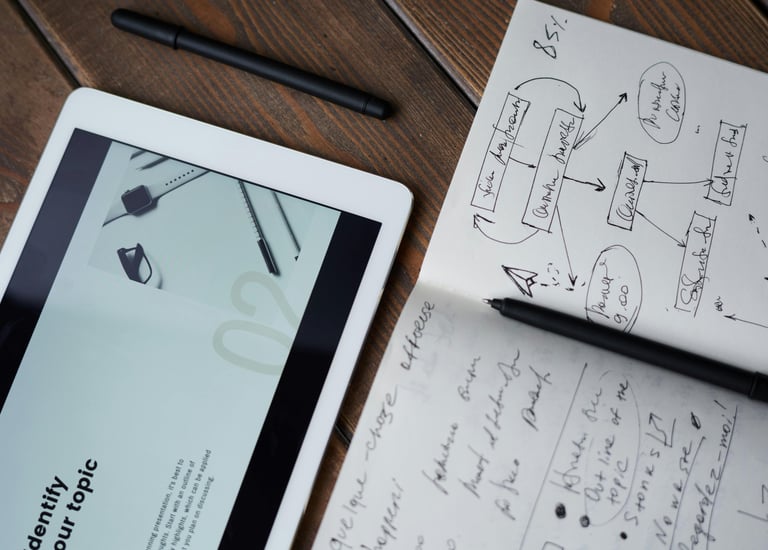 a tablet computer and a pen on a table