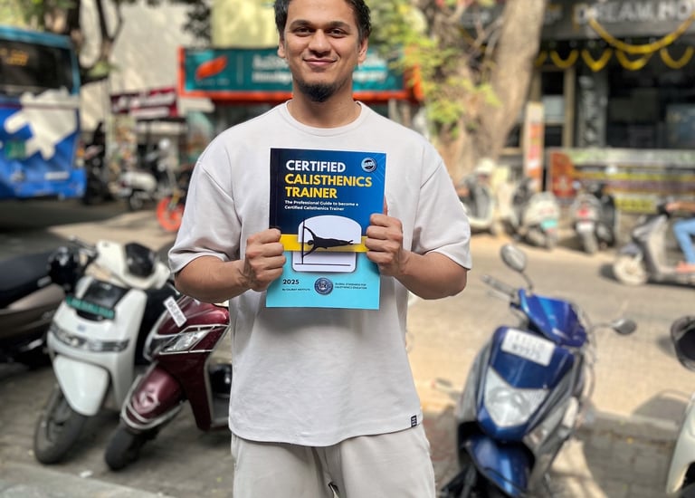 Bilal Ansari holding CALIBAF CCT manual Book with GSCE (global standards for calisthenics education)