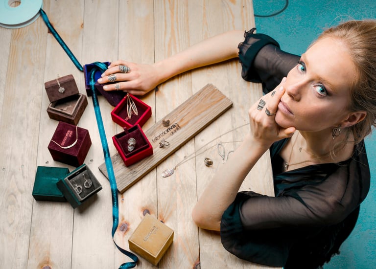 a woman sitting at a table with a ring on her finger