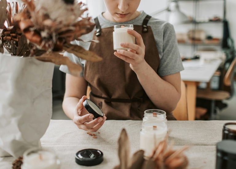 a woman in a brown apron and a vase with flowers