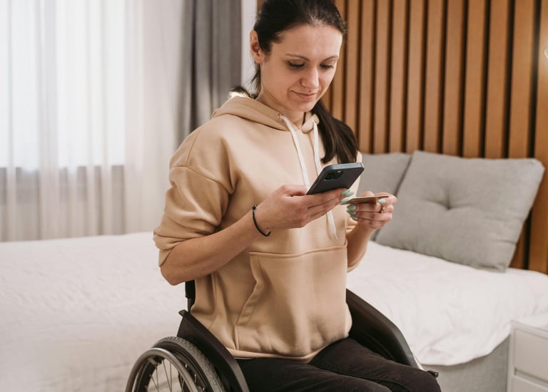 a woman in a wheelchair wheel chair with a cell phone