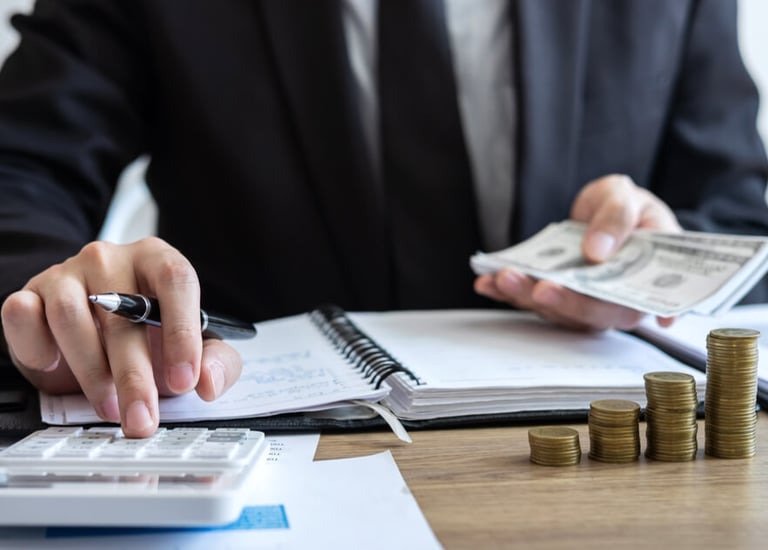 a man in a suit and tie is holding a pen and a notebook. Accounting.Bookkeeping. Taxes.Notary Public