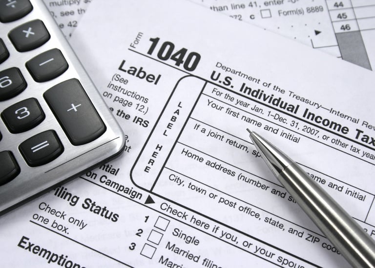 a calculator and pen on a tax form. Taxes 1040. 1040 Form. 