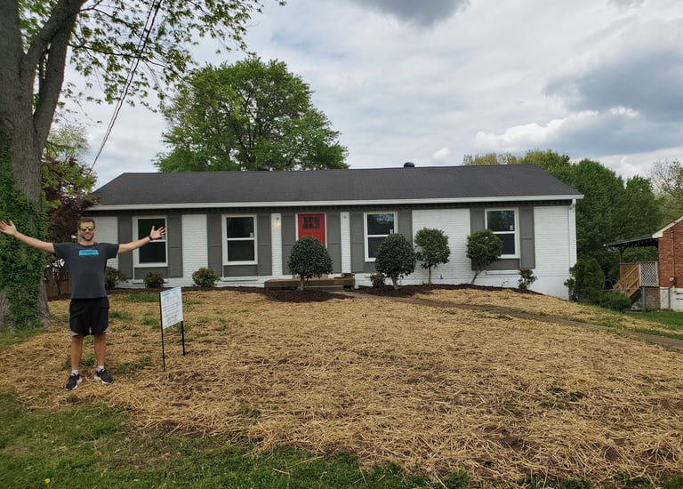 a man standing in front of a house