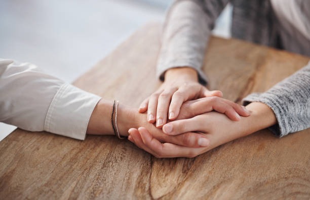 Image of hands touching across a table