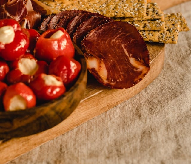 a wooden boarder with cheese and meats