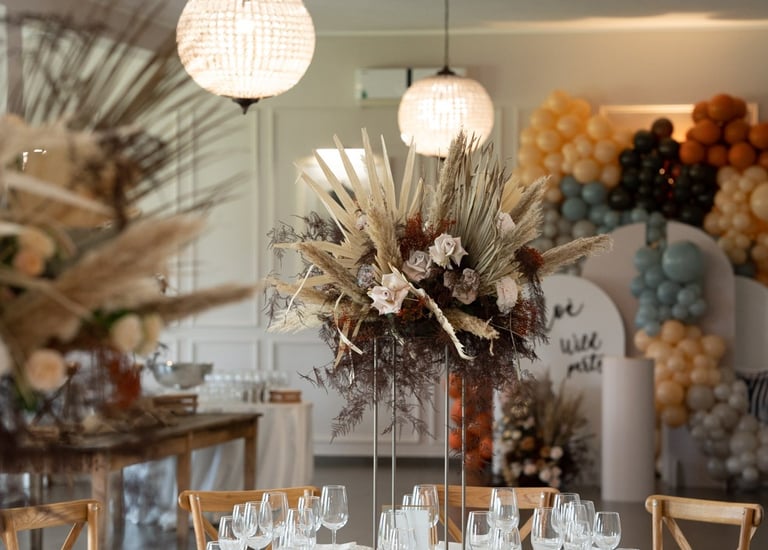 a table with a vase with flowers and a vase with flowers
