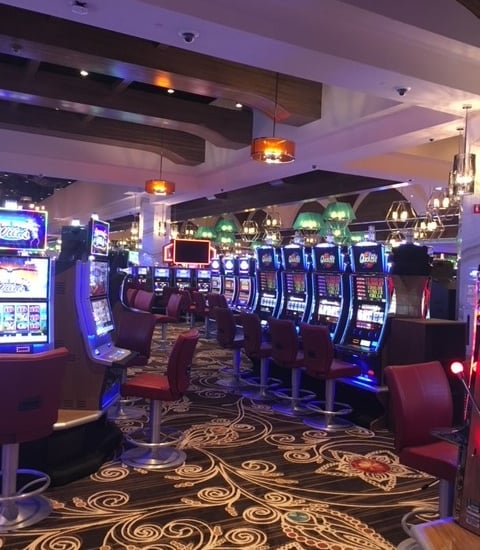 a casino room with a lot of slot machines