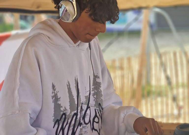 a man in a white hoodie and headphones on a dj - zil