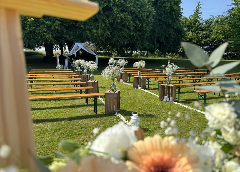 a cross - country wedding ceremony with flowers and a cross