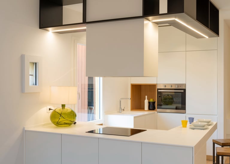 a kitchen with a white counter top and a vase with a vase on it