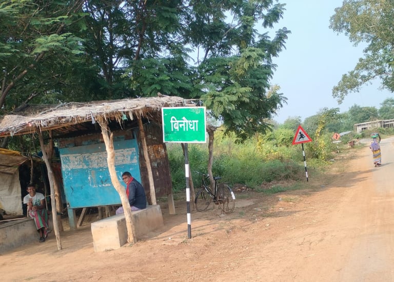 two person sit on the roadside