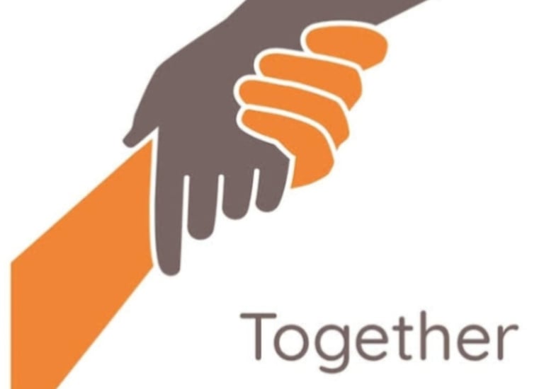 a hand holding green Way Association 