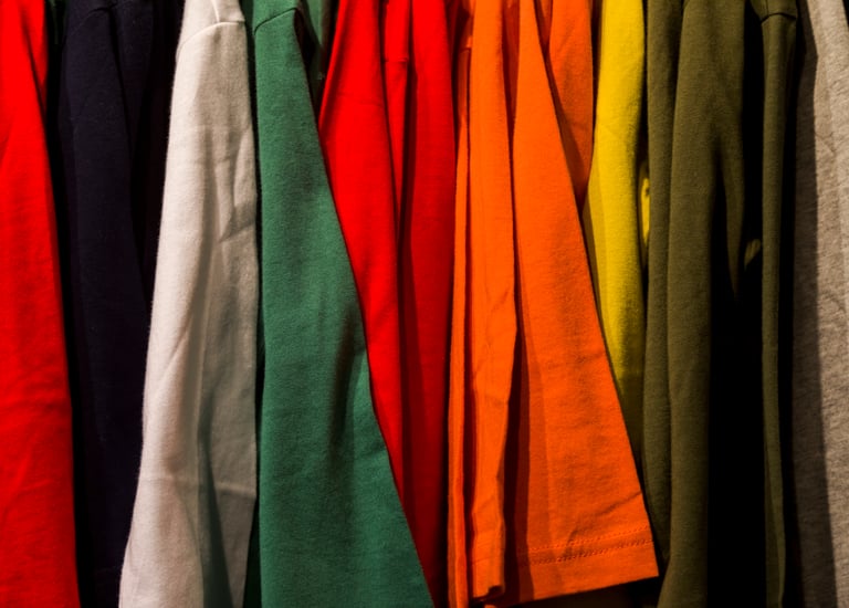 Rack of colourful tshirts on a rack