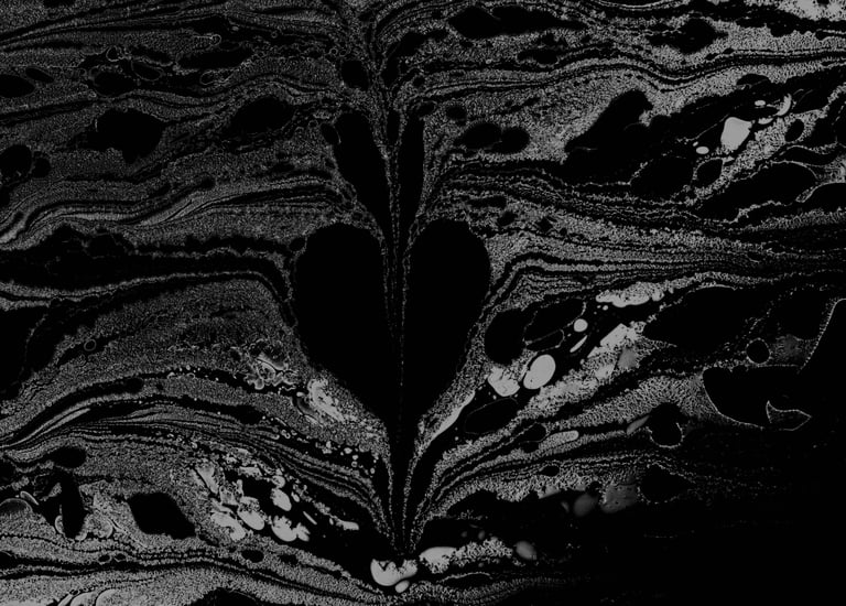 A bleeding heart found emerging from formed and swirling ink on water