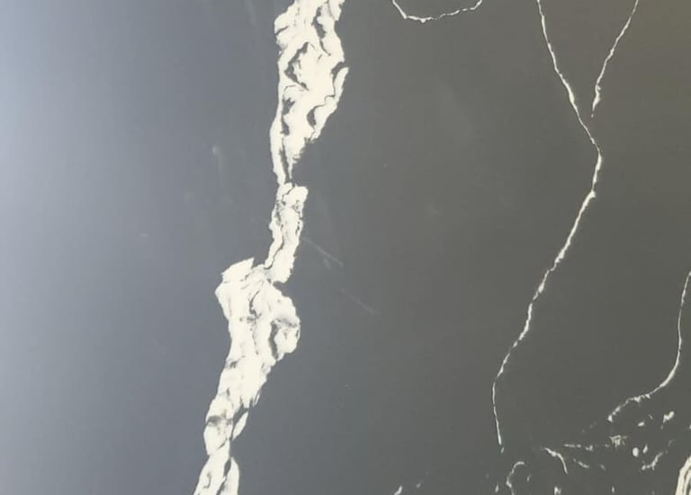 Black quartz slab with polished finish and reflective surface