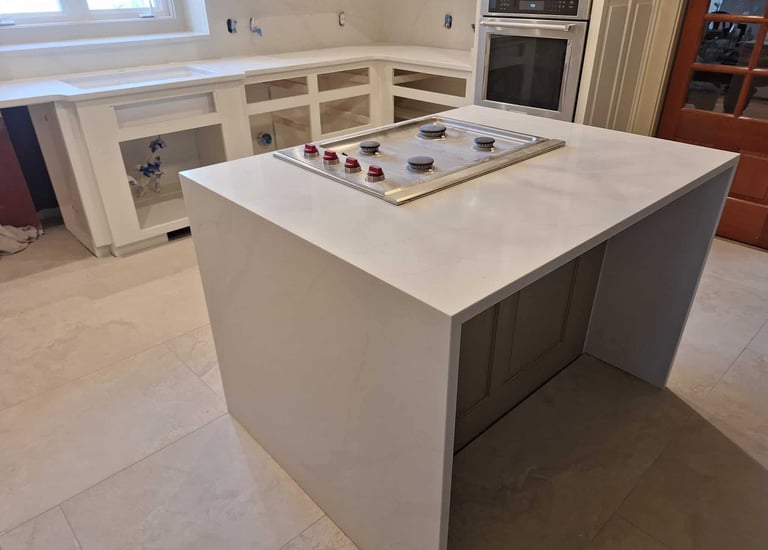 Modern kitchen island with white quartz waterfall countertop