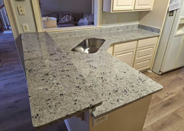 Natural granite countertop with a textured finish and earth tones